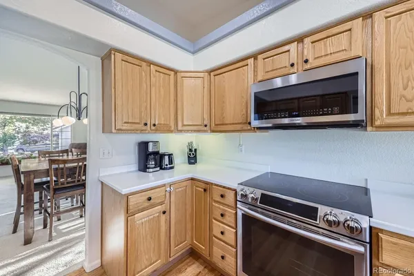 a kitchen with a table chairs and wooden floor
