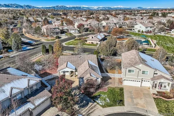 an aerial view of a house with a yard