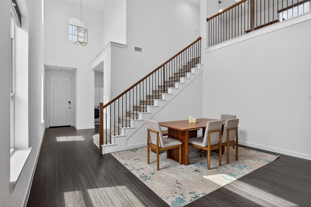 629 Claverton Lane Forney, TX 75126 - Photo 10 of 33 a view of a dining room with wooden floor and white walls