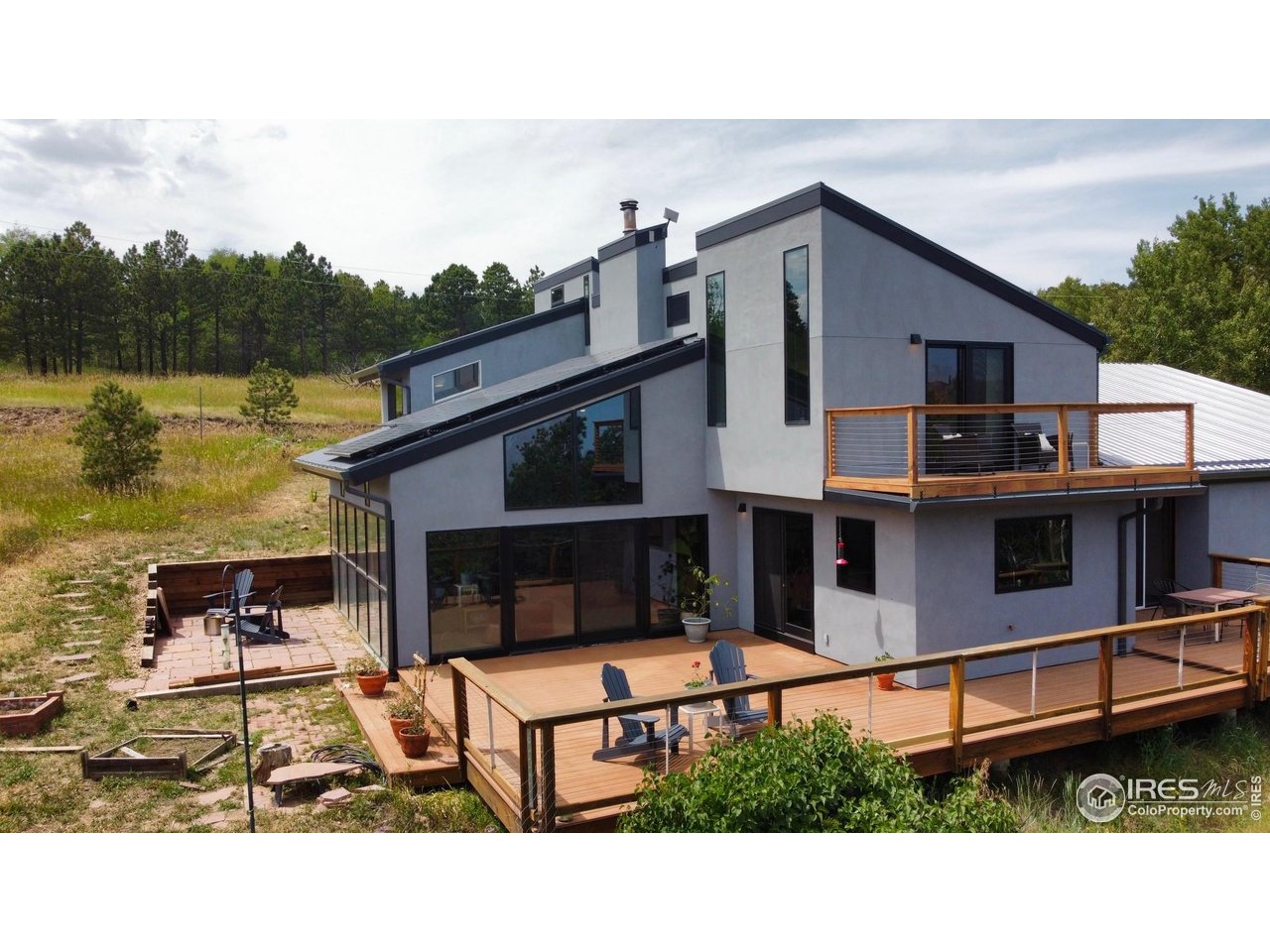a terrace of a house with wooden floor outdoor seating and lake view