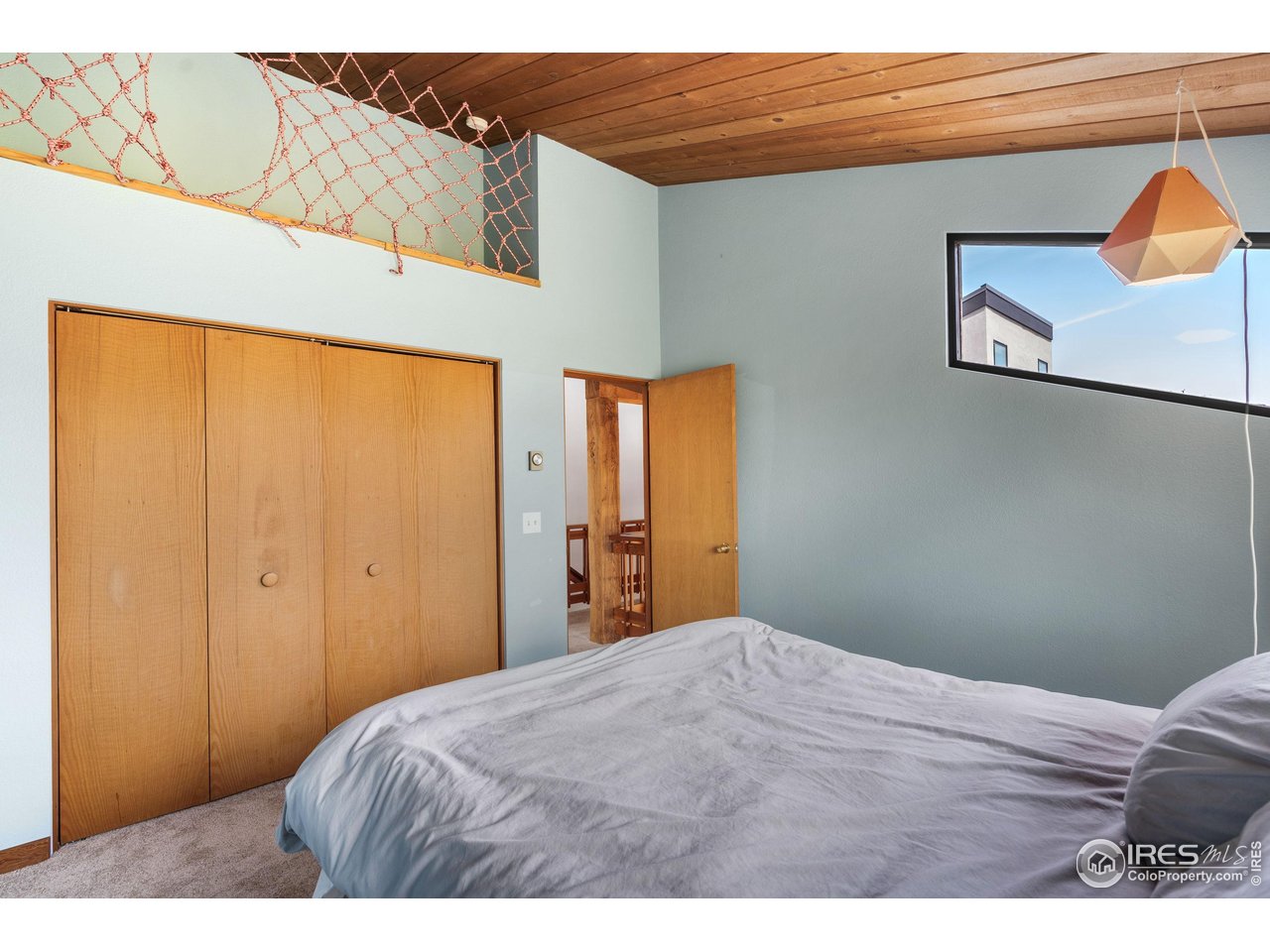 89 Gold Trail Boulder, CO 80302 - Photo 22 of 48 a bedroom with a bed and wooden floor