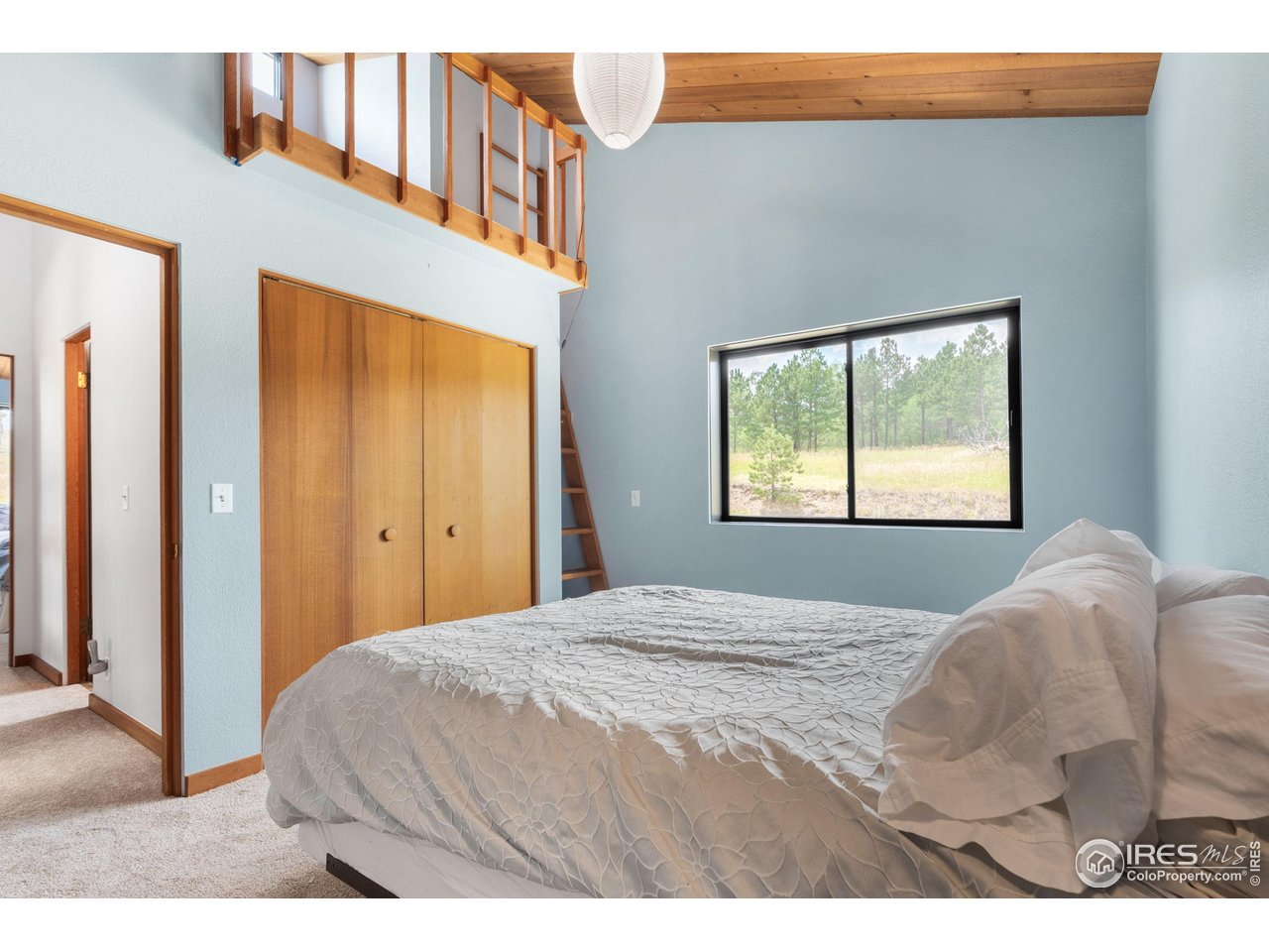 89 Gold Trail Boulder, CO 80302 - Photo 24 of 48 a bedroom with a bed and a window