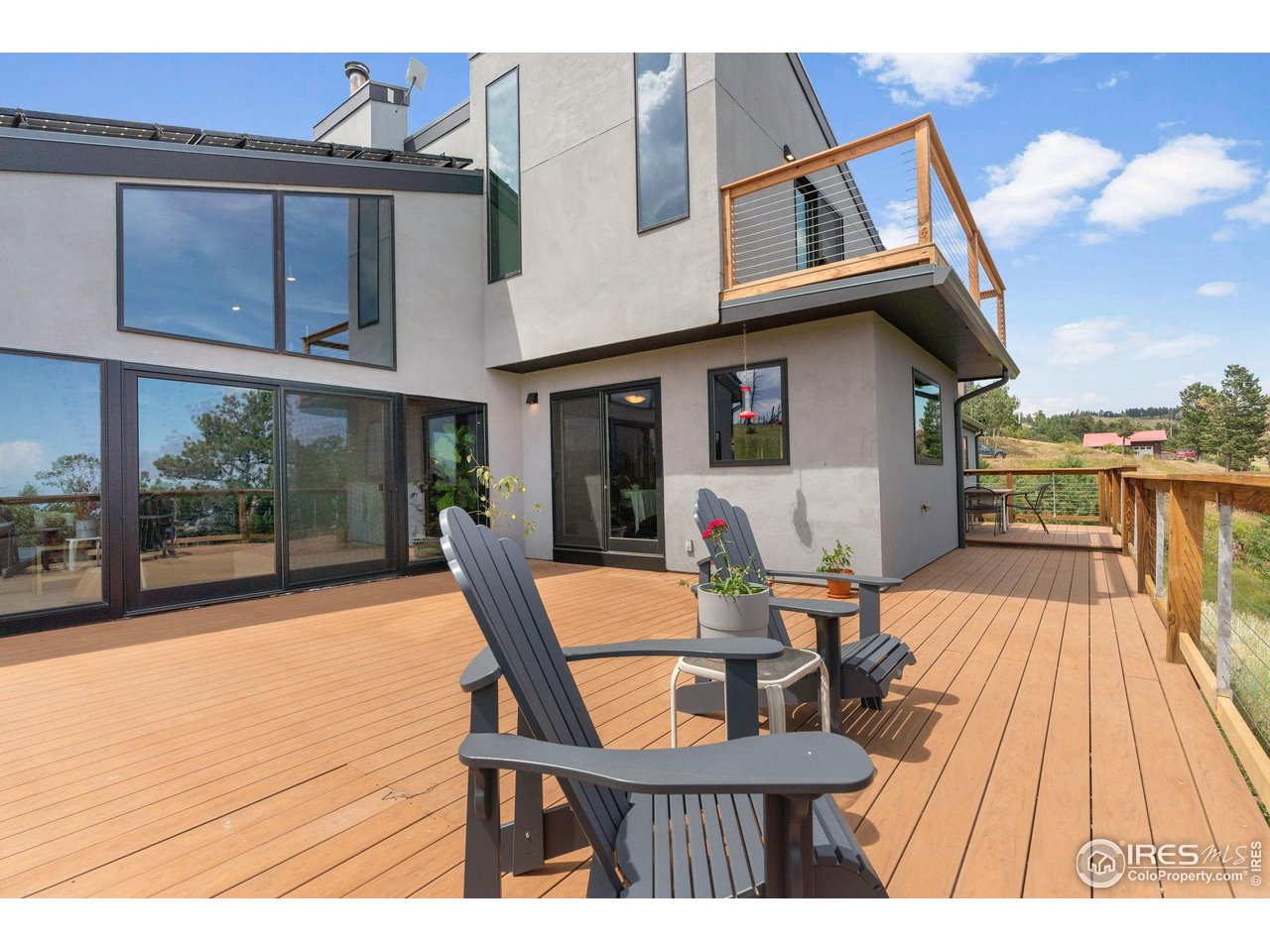 89 Gold Trail Boulder, CO 80302 - Photo 33 of 48 a view of a patio with table and chairs with wooden floor and fence