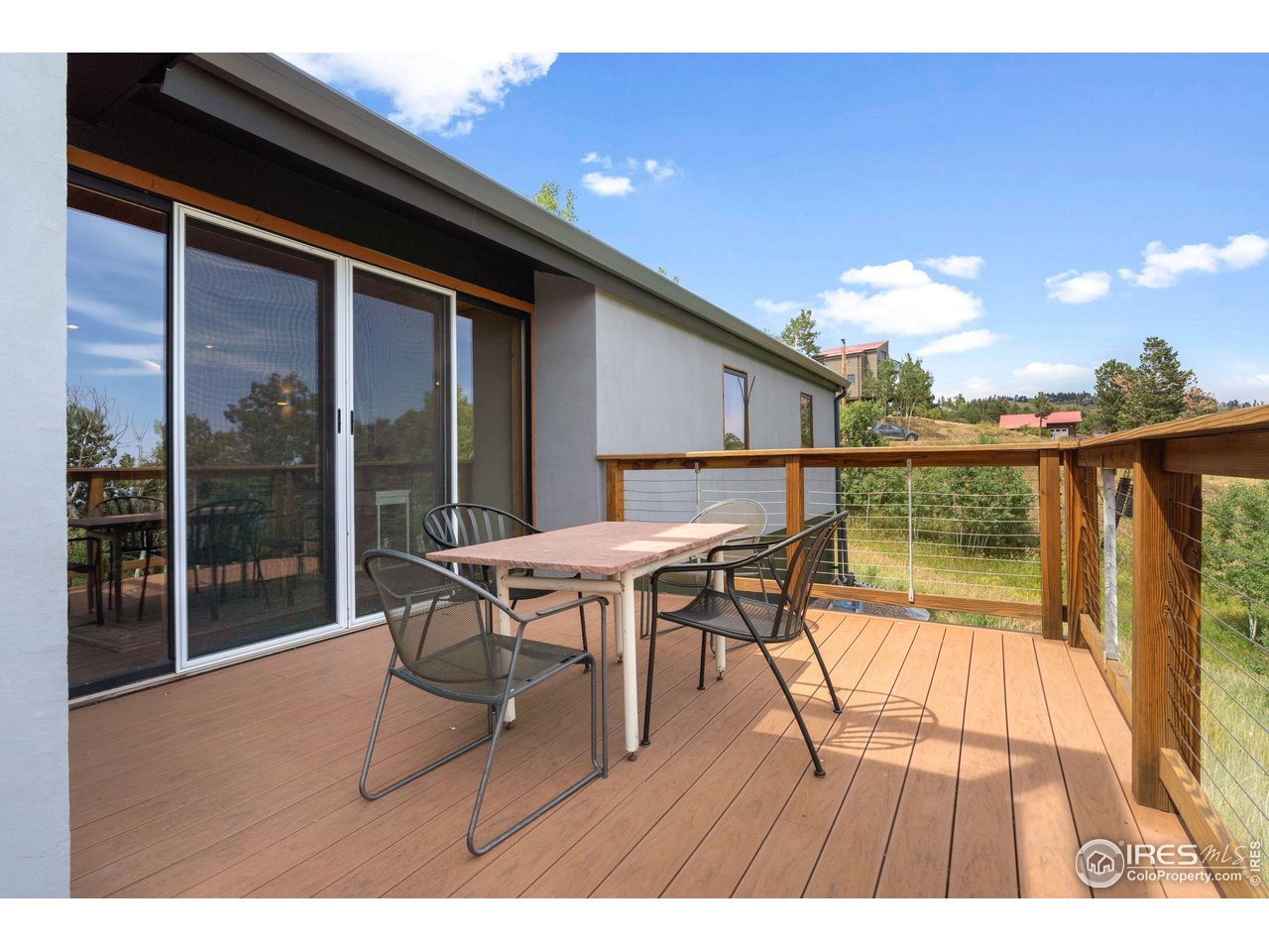 89 Gold Trail Boulder, CO 80302 - Photo 36 of 48 a balcony with wooden floor table and chairs