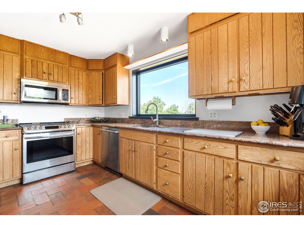 89 Gold Trail Boulder, CO 80302 - Photo 6 of 48 a kitchen with stainless steel appliances granite countertop a stove a sink and a microwave