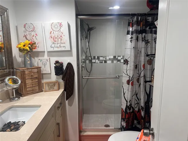 a bathroom with a sink mirror toilet and bathtub