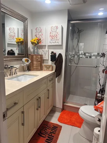 a bathroom with a sink a mirror and a shower