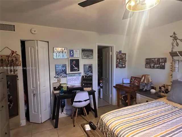 a bedroom with a bed a desk and chair