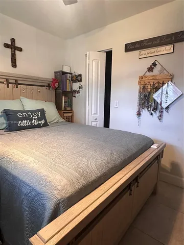 a bedroom with a bed and a walk in closet