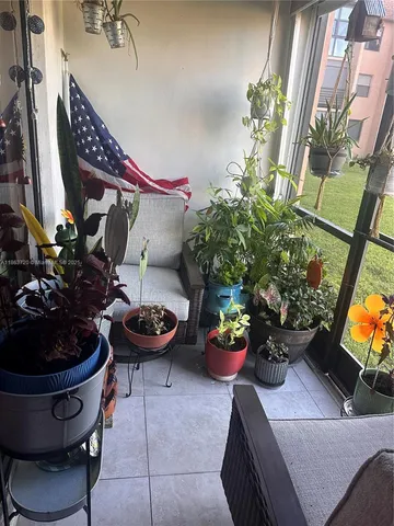 a living room with furniture and flowers
