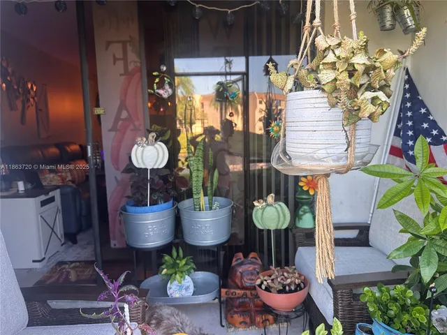 a dining room with furniture and a potted plant