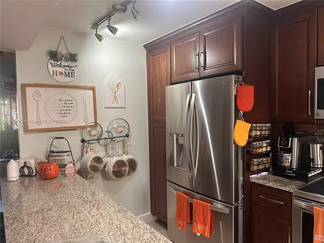 a kitchen with refrigerator and washer