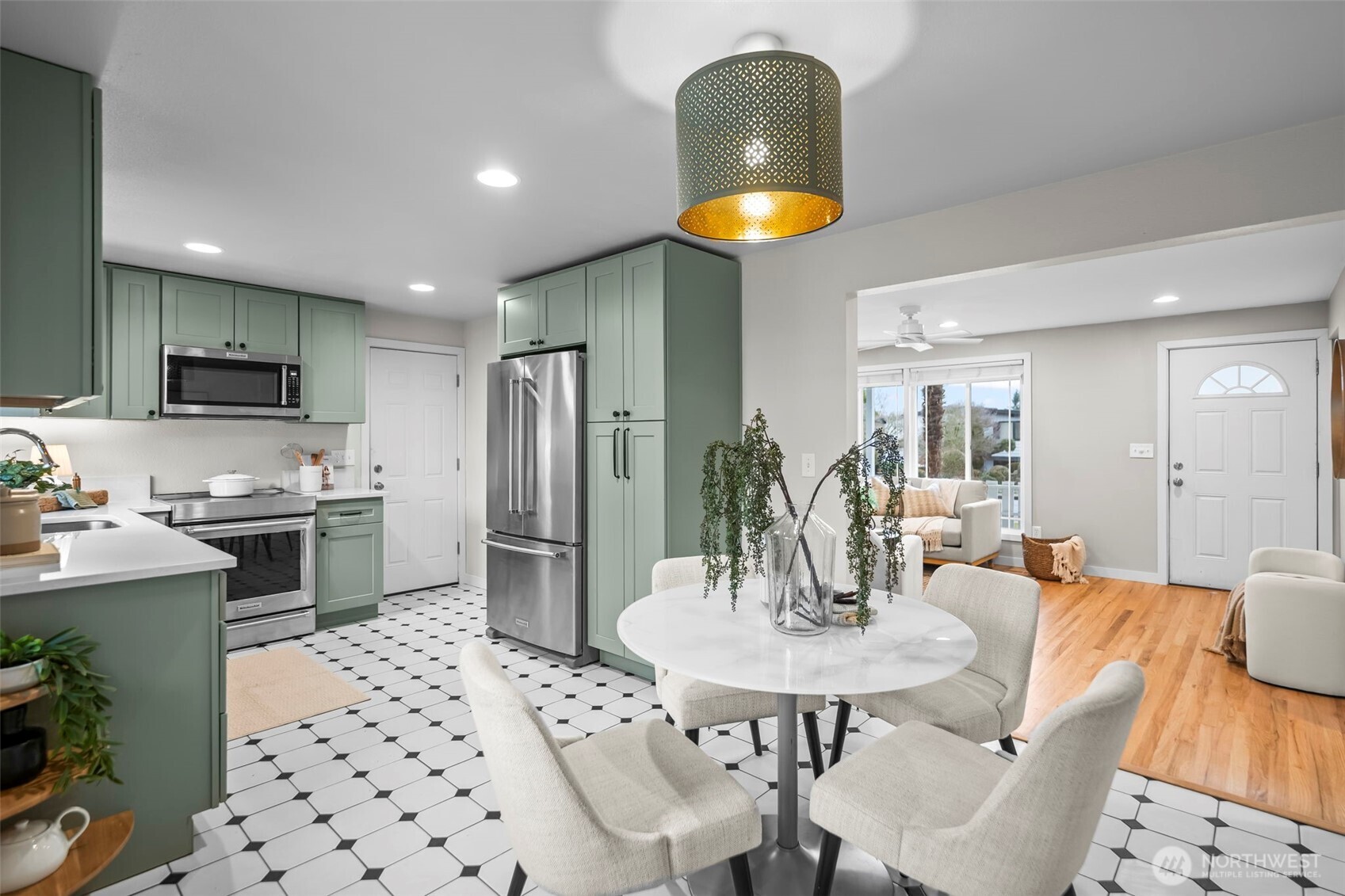 16519 116th Place Southeast Renton, WA 98058 - Photo 11 of 28 a kitchen with stainless steel appliances kitchen island granite countertop a sink a stove a dining table and chairs