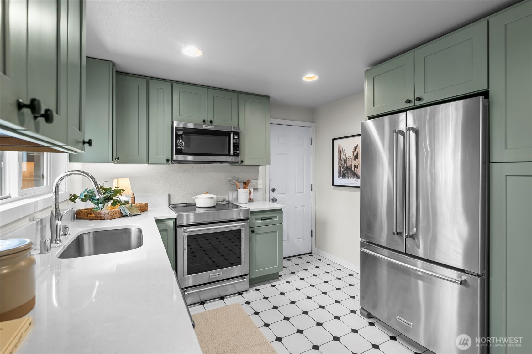 16519 116th Place Southeast Renton, WA 98058 - Photo 13 of 28 a kitchen with stainless steel appliances granite countertop a refrigerator stove and sink
