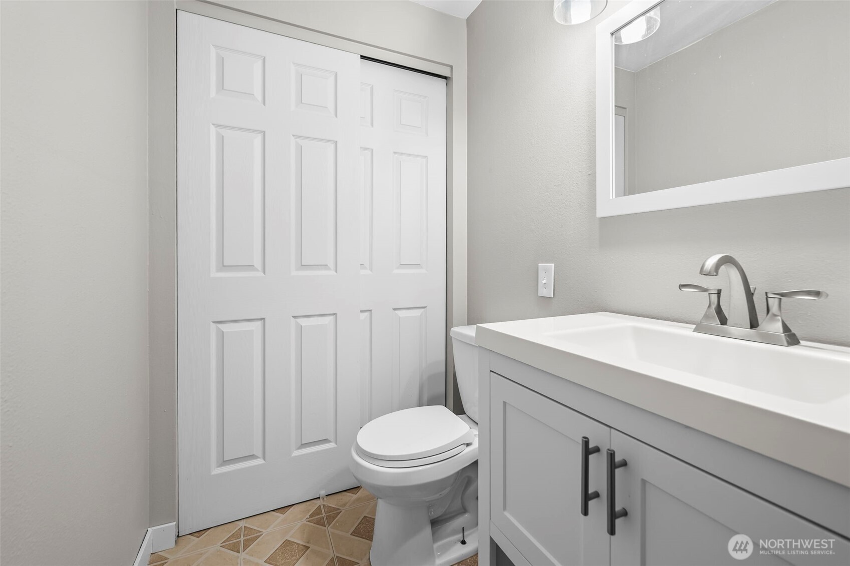 16519 116th Place Southeast Renton, WA 98058 - Photo 19 of 28 a bathroom with a sink a toilet and vanity