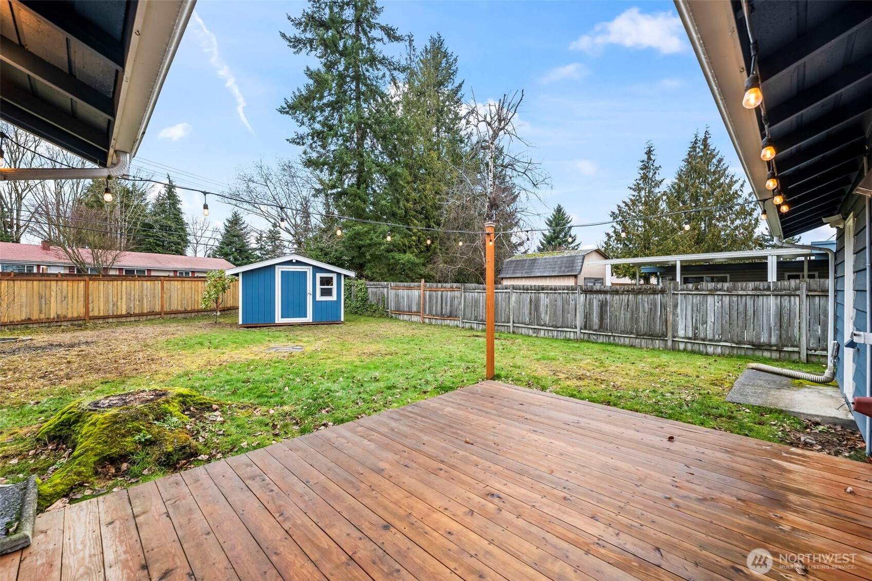 16519 116th Place Southeast Renton, WA 98058 - Photo 25 of 28 a view of a backyard with table and chairs and wooden fence