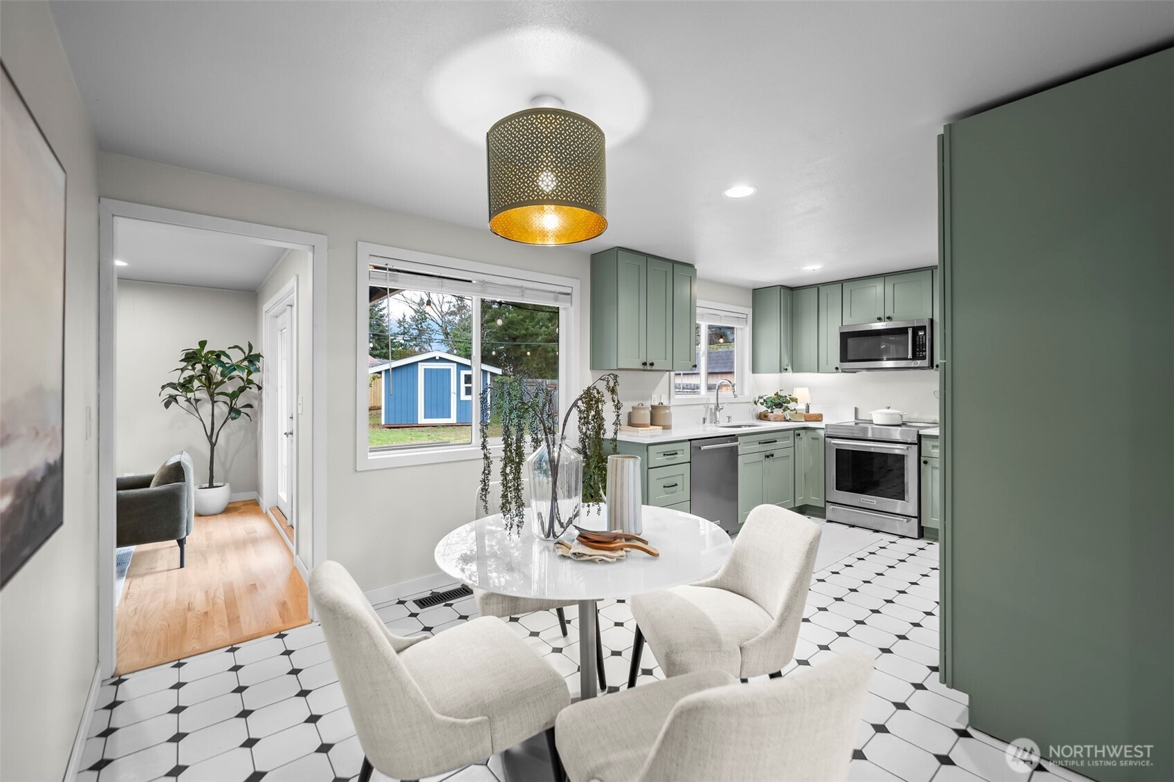 16519 116th Place Southeast Renton, WA 98058 - Photo 10 of 28 a living room with stainless steel appliances kitchen island granite countertop a stove a sink a dining table and chairs