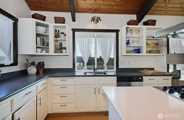 a kitchen with stainless steel appliances granite countertop a sink and cabinets