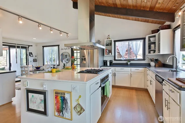 a kitchen with a stove top oven sink and cabinets