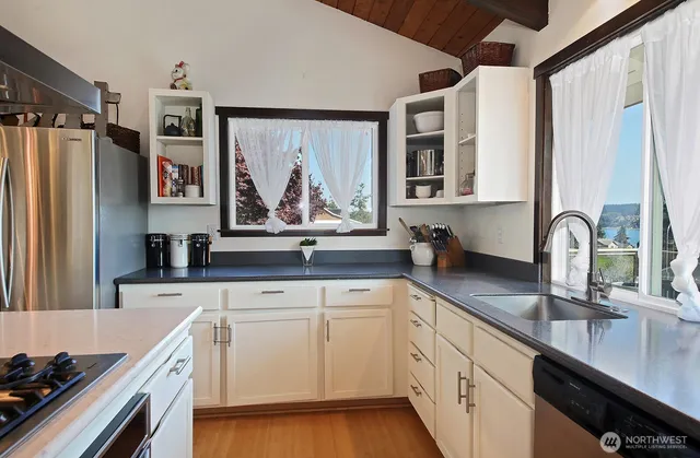 a kitchen with a sink stove and refrigerator