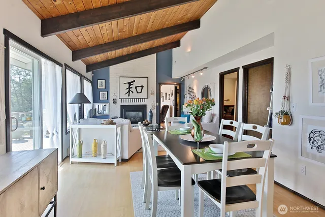 a dining room with furniture and a large window