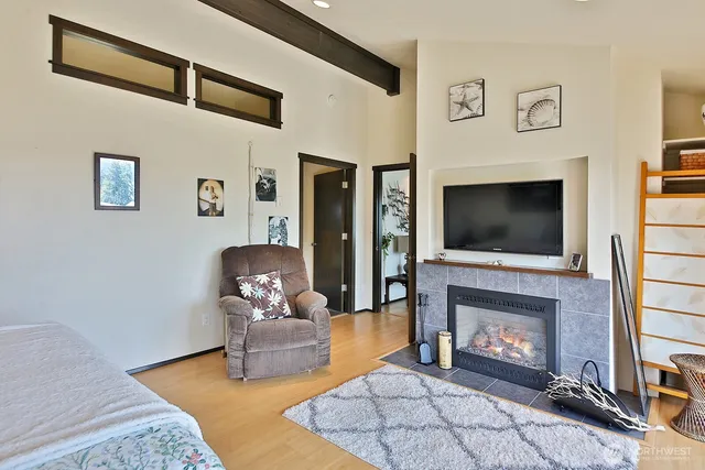 a living room with furniture fireplace and flat screen tv
