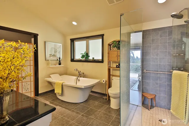 a bathroom with a bathtub toilet and shower