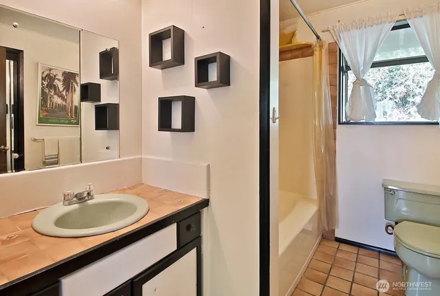 a bathroom with a sink toilet and mirror