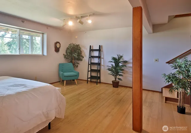 a bedroom with a bed and a potted plant