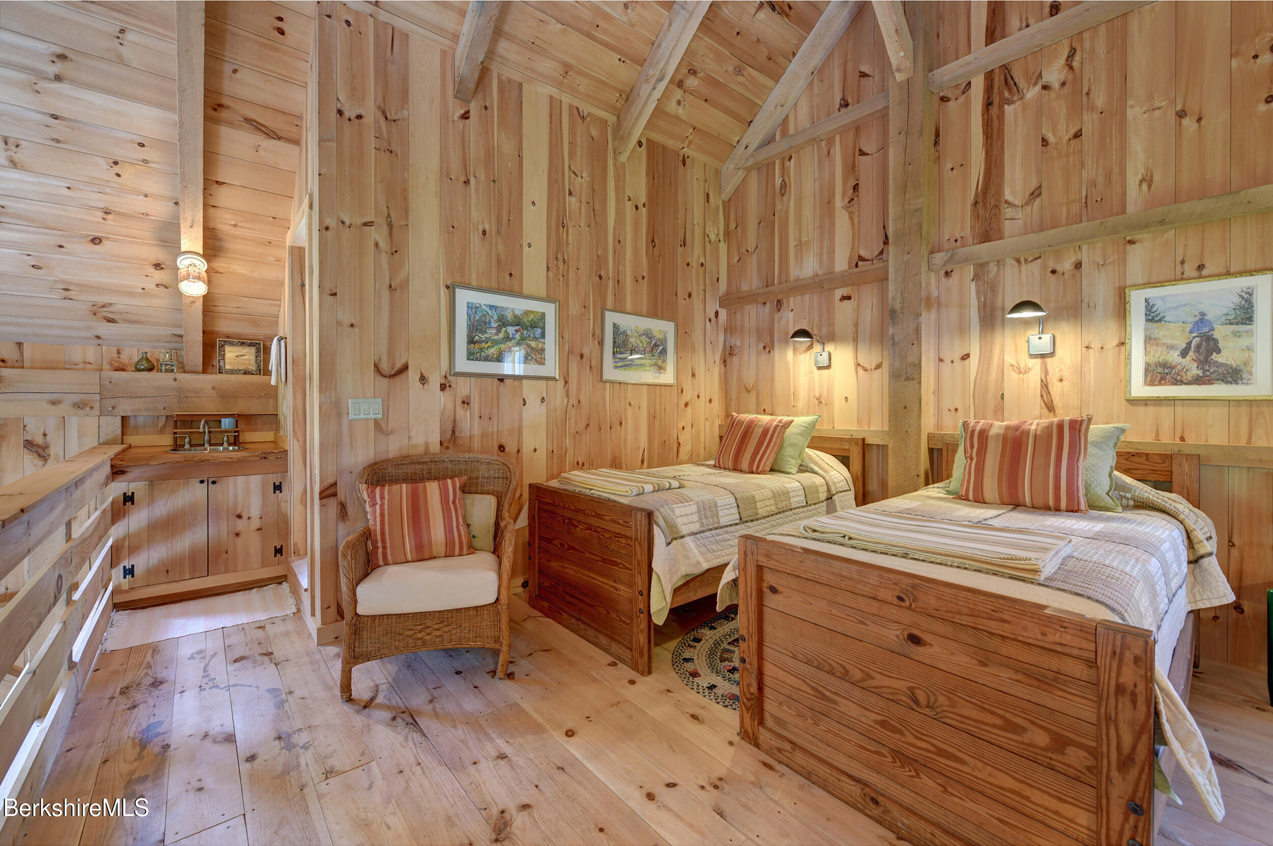 66 Access Road Becket, MA 01223 - Photo 18 of 54 a spacious bedroom with two beds and a couch