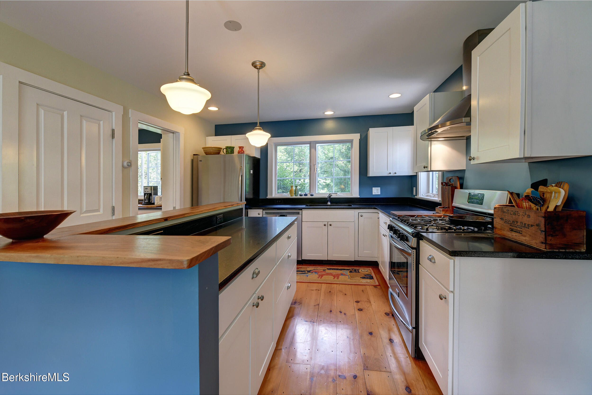 66 Access Road Becket, MA 01223 - Photo 26 of 54 a kitchen with stainless steel appliances a sink stove and cabinets