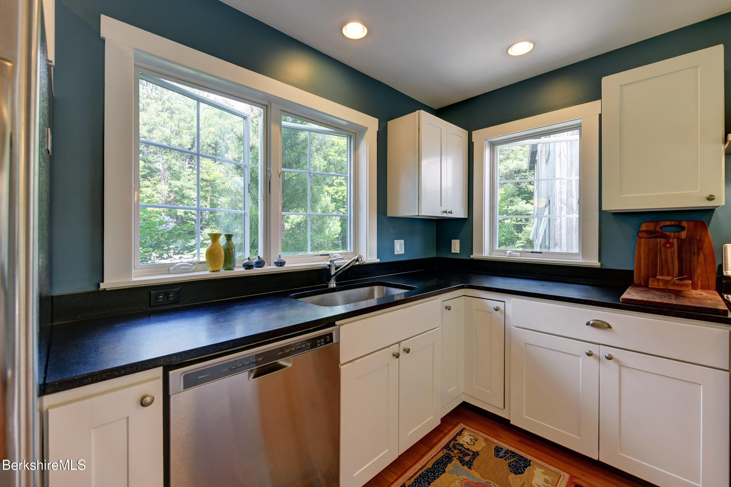 66 Access Road Becket, MA 01223 - Photo 27 of 54 a kitchen with granite countertop white cabinets window and sink