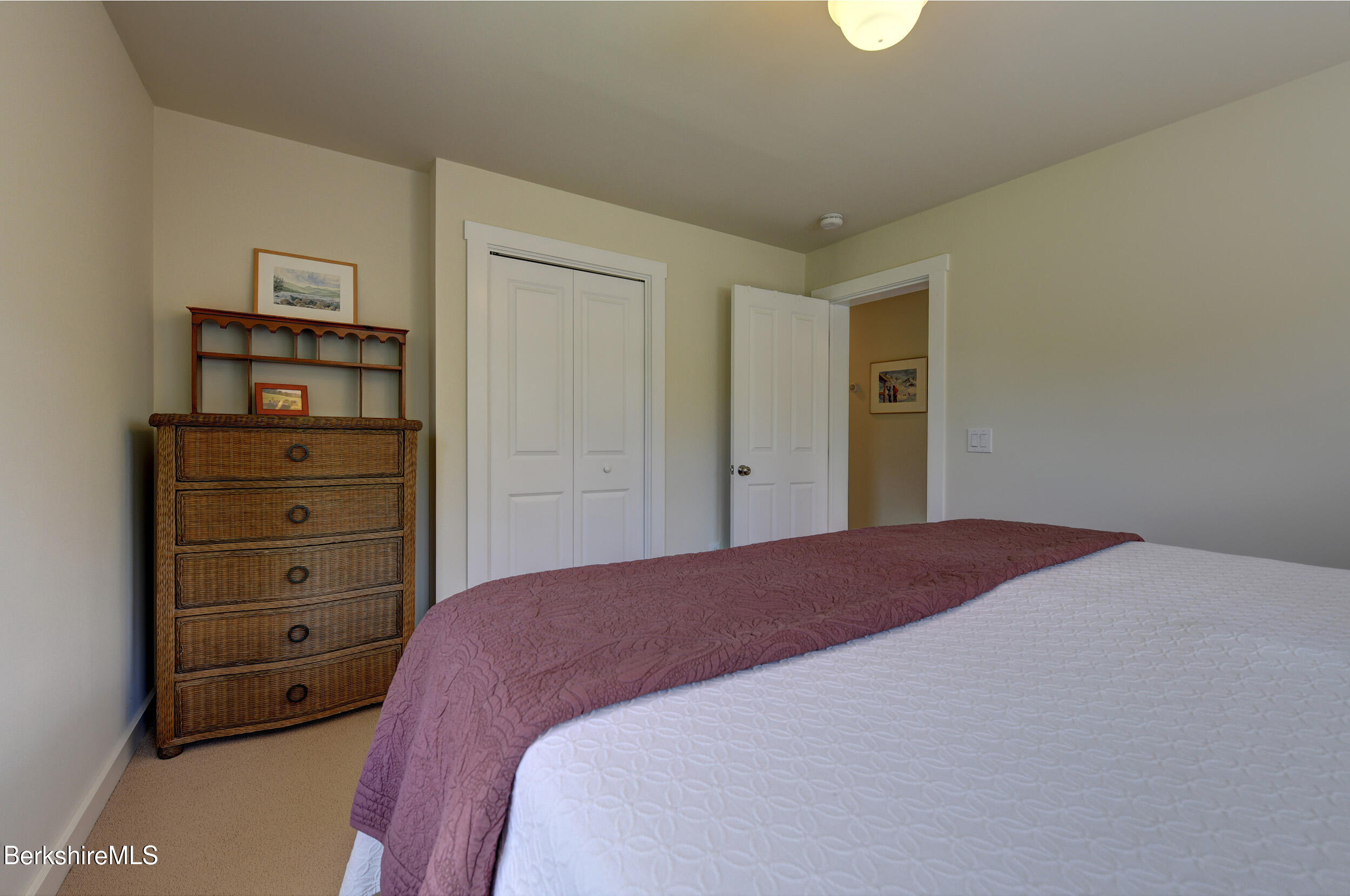 66 Access Road Becket, MA 01223 - Photo 33 of 54 a bedroom with a bed and a dresser