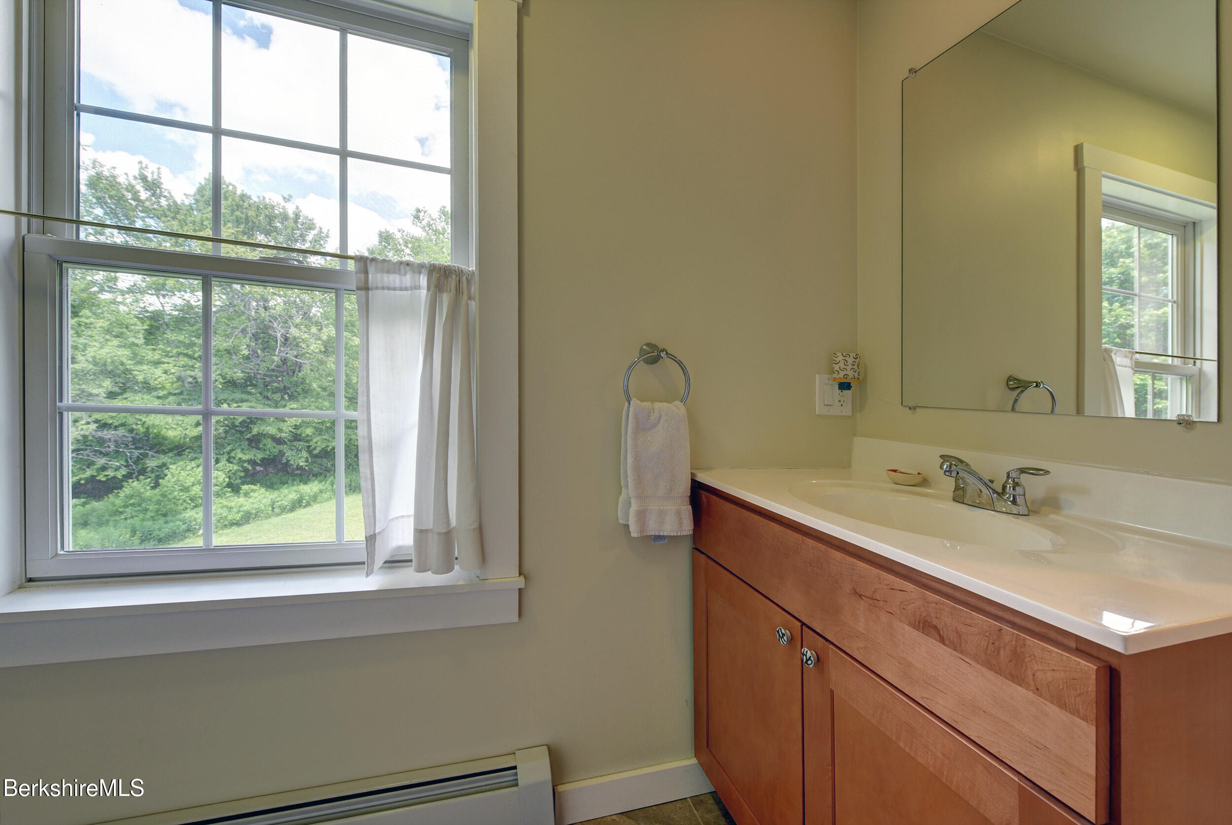 66 Access Road Becket, MA 01223 - Photo 38 of 54 a bathroom with a granite countertop sink and a window