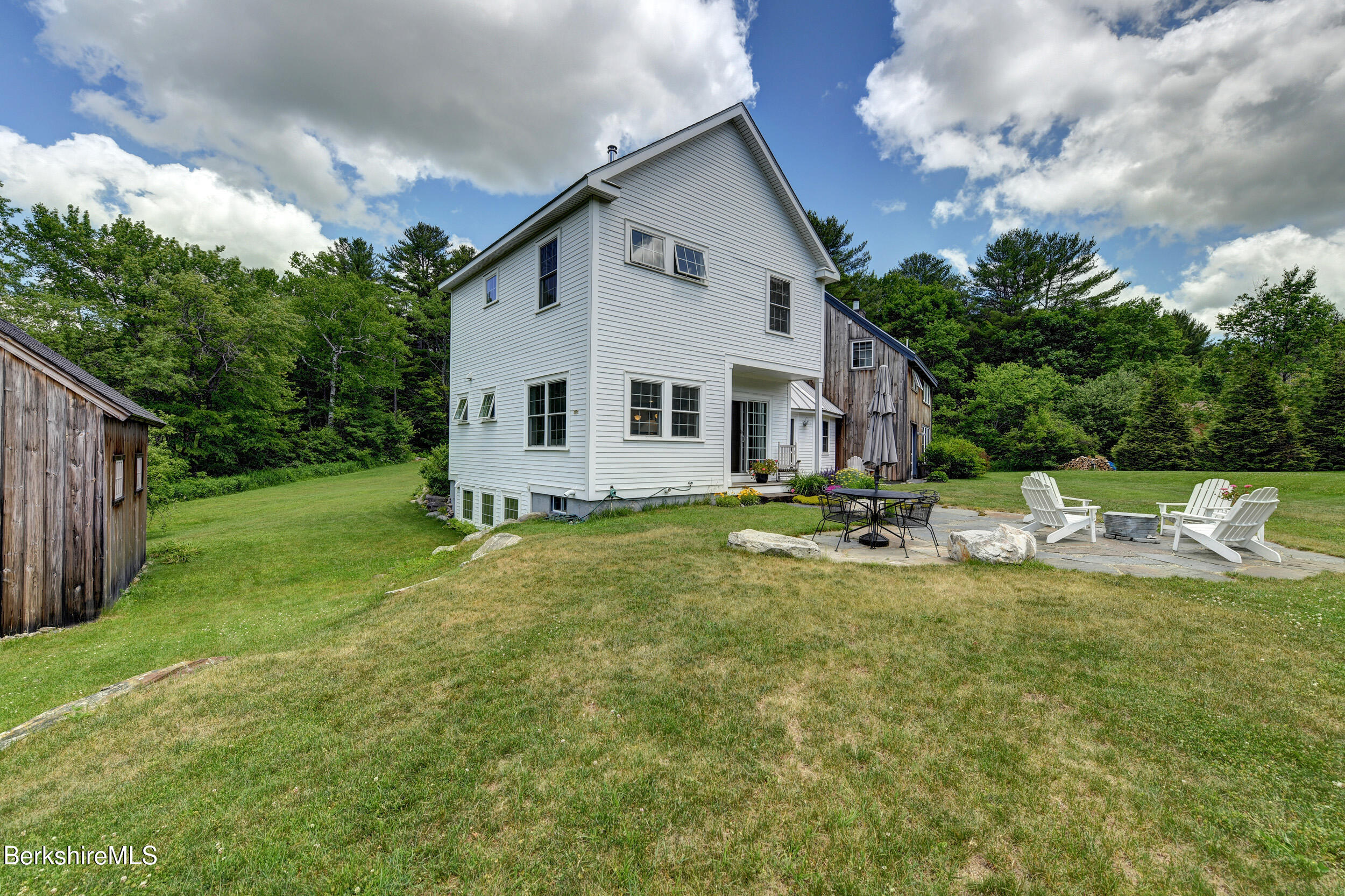 66 Access Road Becket, MA 01223 - Photo 41 of 54 a view of a house with backyard and sitting area