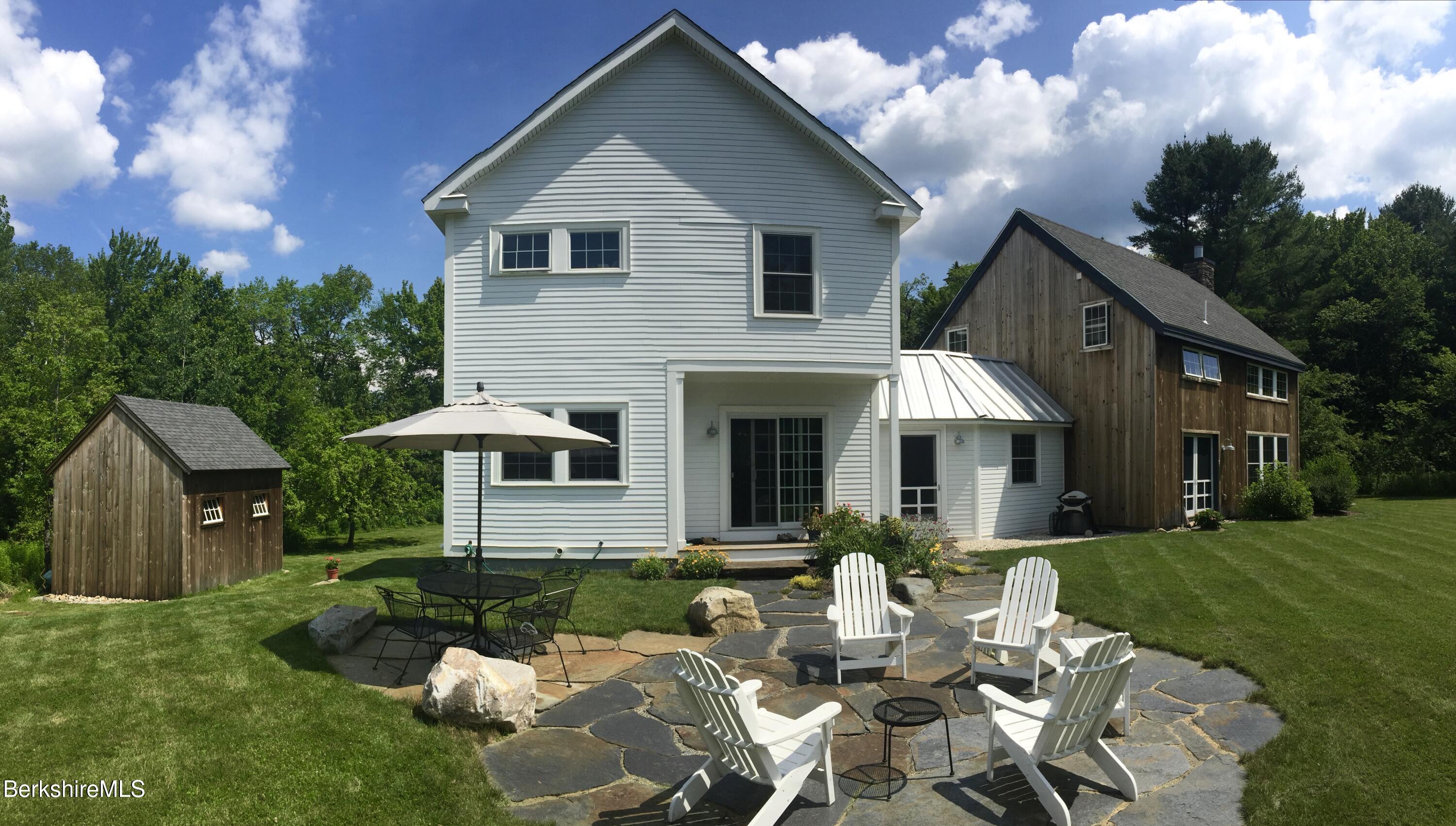 66 Access Road Becket, MA 01223 - Photo 51 of 54 a view of a house with a yard patio and fire pit
