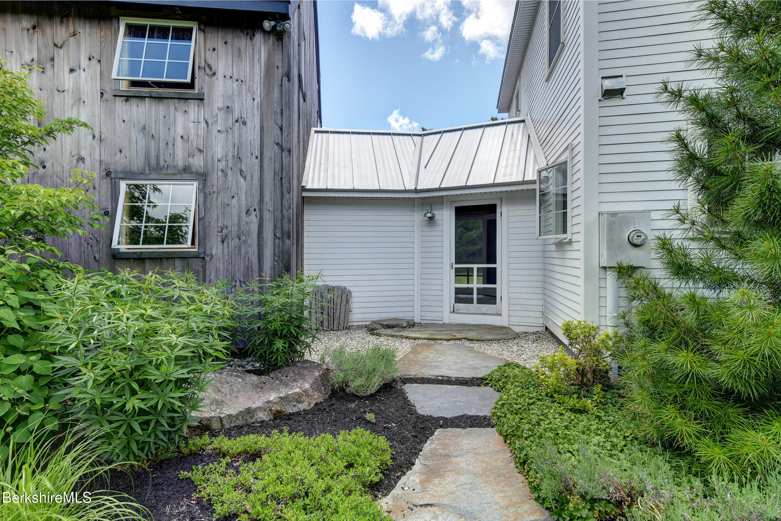 66 Access Road Becket, MA 01223 - Photo 6 of 54 a front view of a house with garden