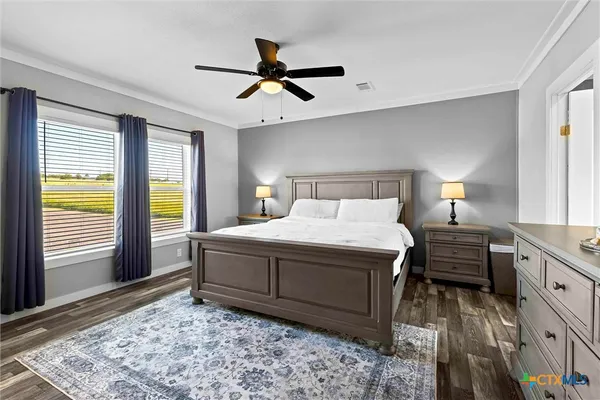 a bedroom with a bed a lamp and a dresser