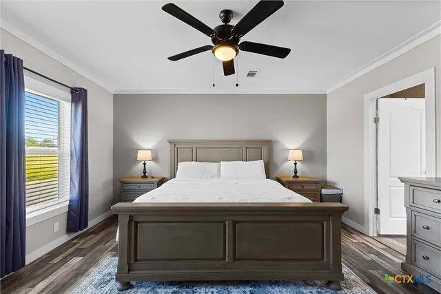 a bathroom with double vanity sinks a large mirror and a window