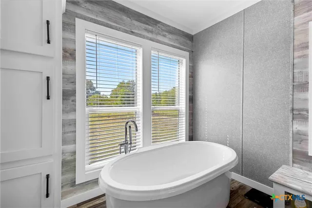 a spacious bathroom with a double vanity sink and a mirror