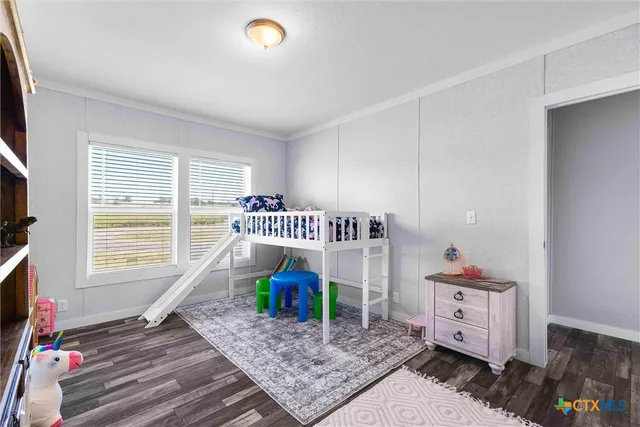 a bedroom with furniture and a window