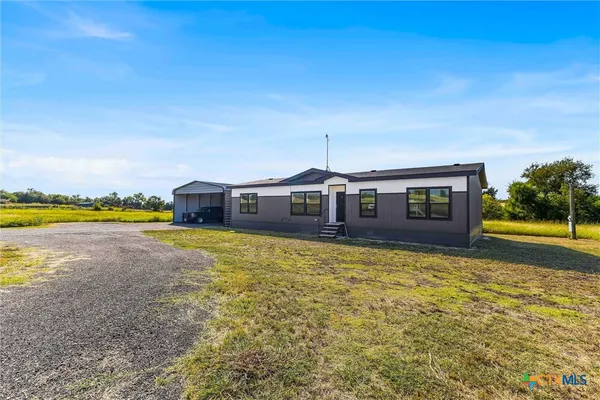 a view of a house with swimming pool and a yard