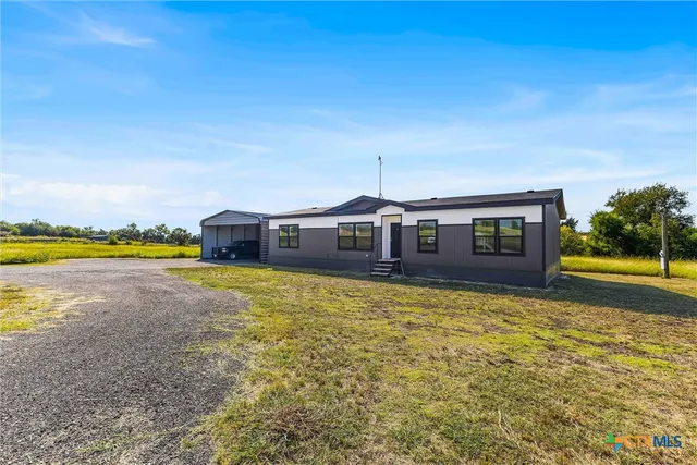 a view of a house with swimming pool and a yard