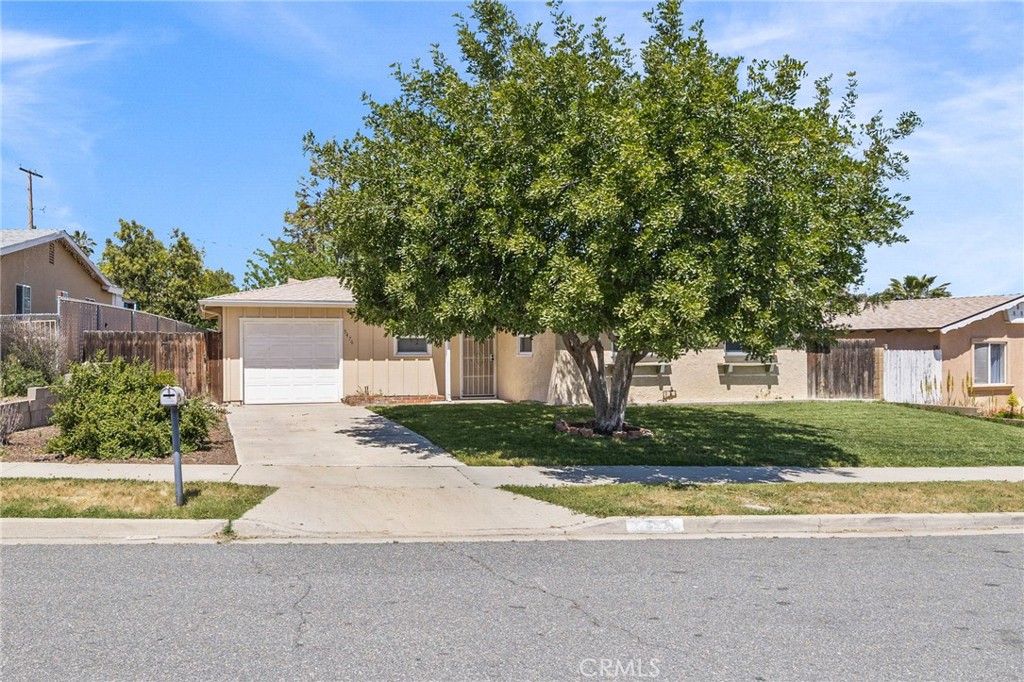 5476 Lewis Avenue Riverside, CA 92503 - Photo 1 of 1 a house that has a tree in front of it