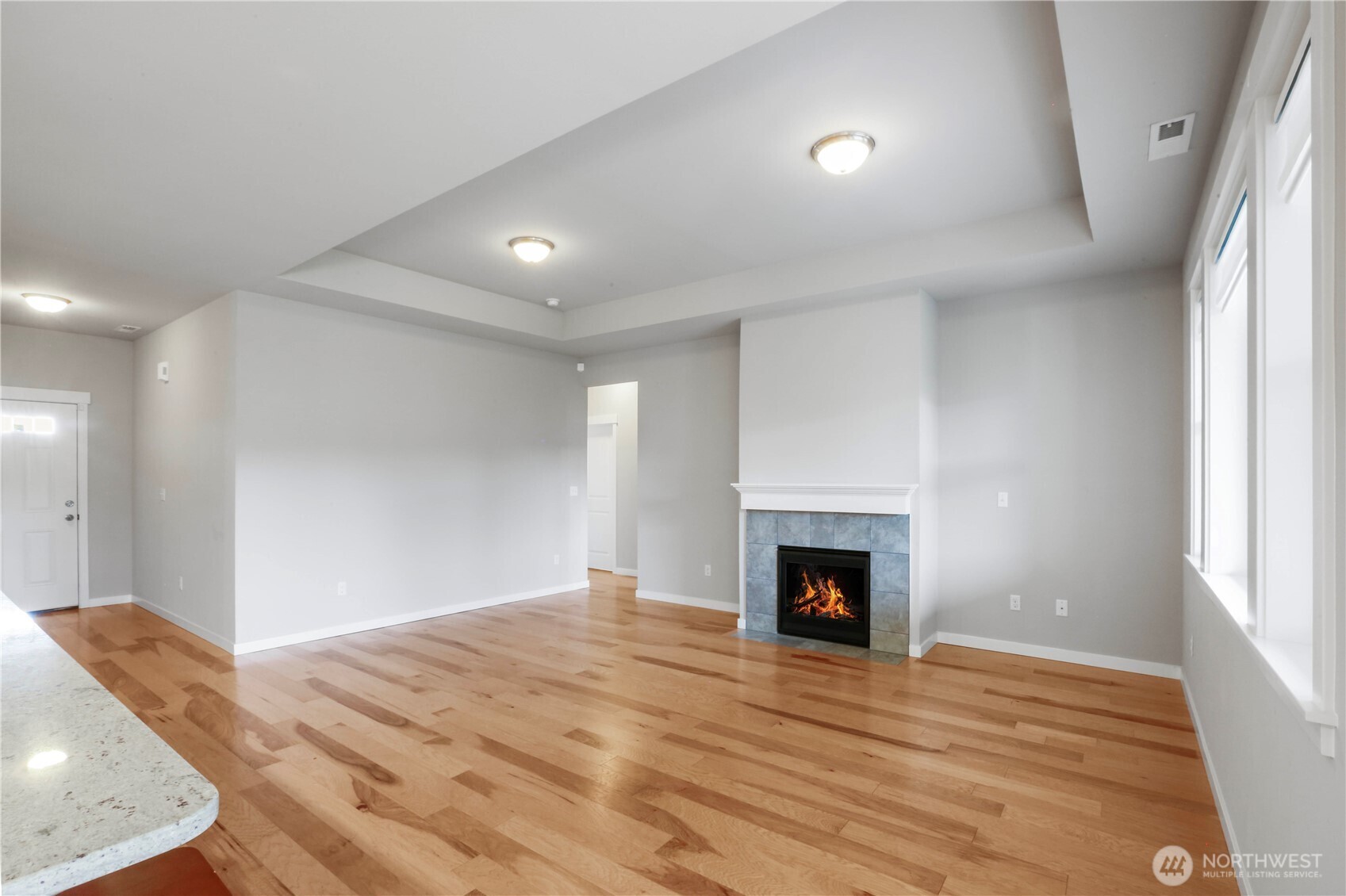 4192 McLaughlin Road Mount Vernon, WA 98273 - Photo 13 of 40 a view of an empty room with wooden floor fireplace and a window