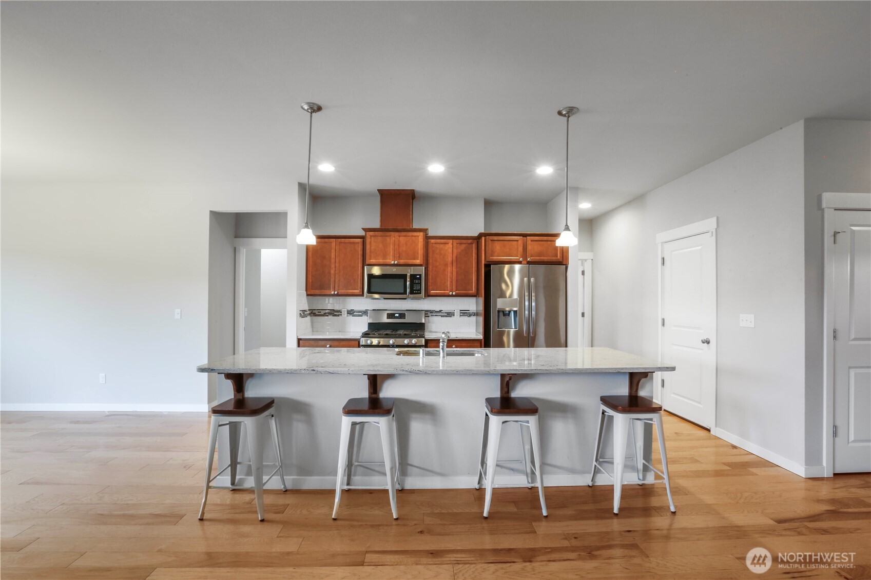 4192 McLaughlin Road Mount Vernon, WA 98273 - Photo 14 of 40 a kitchen with stainless steel appliances kitchen island granite countertop a dining table chairs sink and cabinets