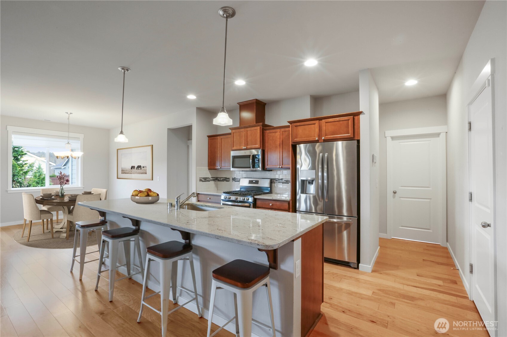 4192 McLaughlin Road Mount Vernon, WA 98273 - Photo 15 of 40 a kitchen with stainless steel appliances granite countertop a refrigerator a sink dishwasher a stove and a dining table with wooden floor