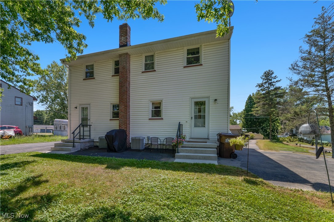 9925 Struthers Road New Middletown, OH 44442 - Photo 2 of 12 Rear view of property with a chimney and a yard