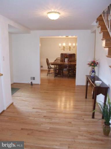 12409 Over Ridge Road Potomac, MD 20854 - Photo 11 of 30 a view of a living room and kitchen with furniture wooden floor and windows