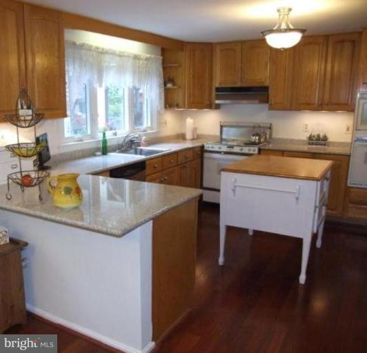 12409 Over Ridge Road Potomac, MD 20854 - Photo 15 of 30 a kitchen with a sink a microwave and cabinets